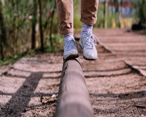 Close up of comfortable shoes walking along a concrete pathway in an urban setting